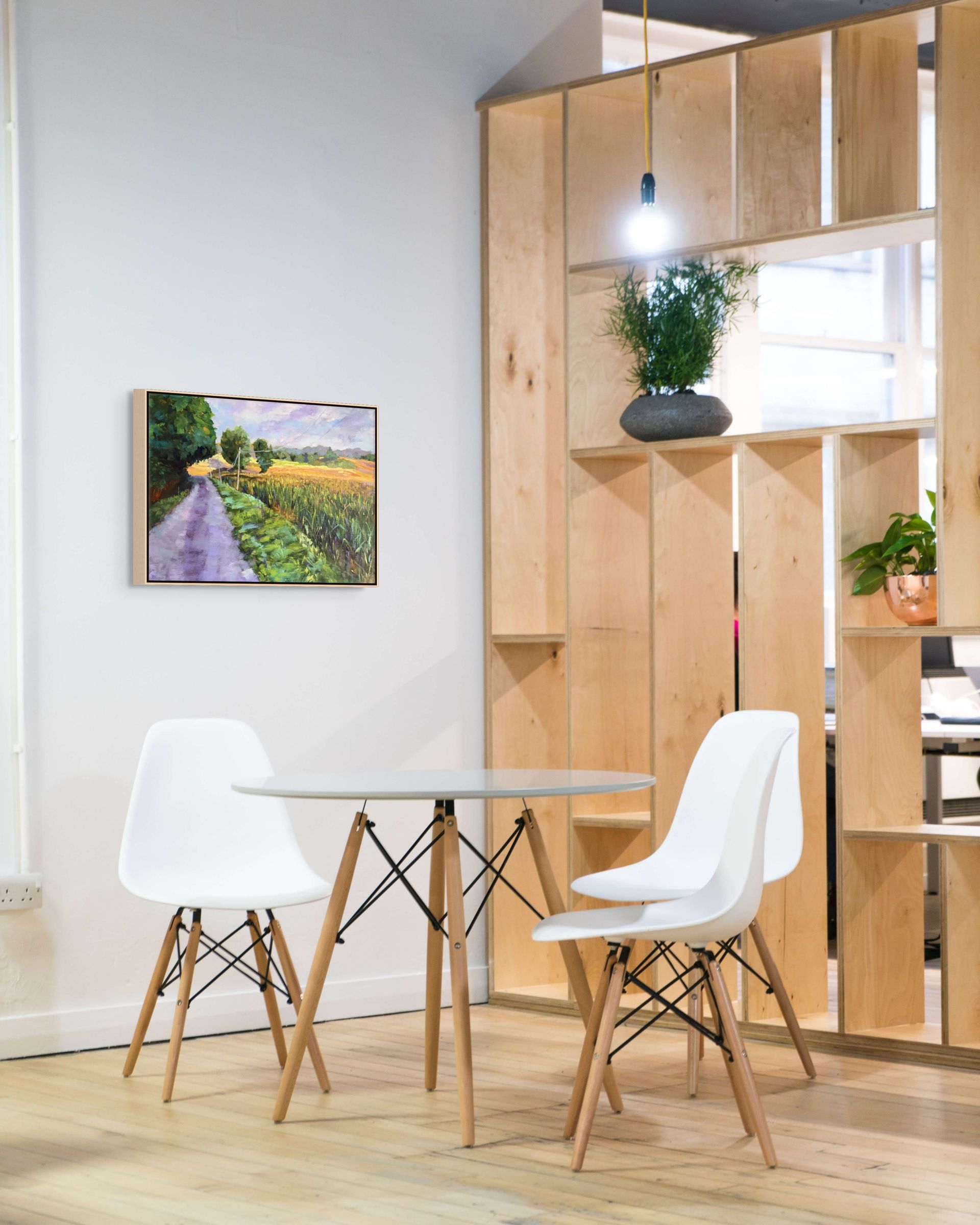"Morning Meadows original oil painting displayed with Danish style chairs, by Sally Herriott"