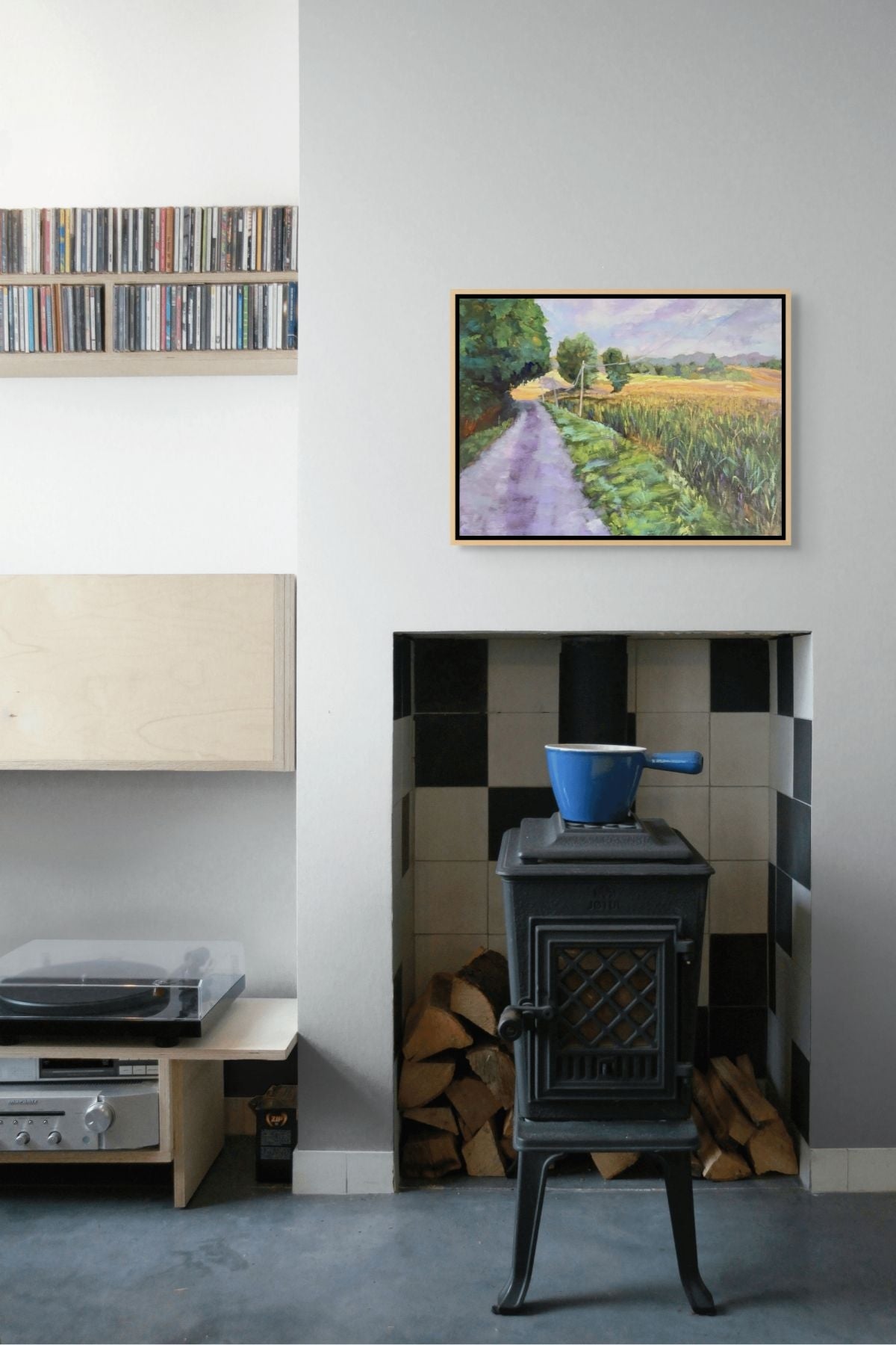"Morning Meadows original oil painting above a rustic fireplace, by Sally Herriott"